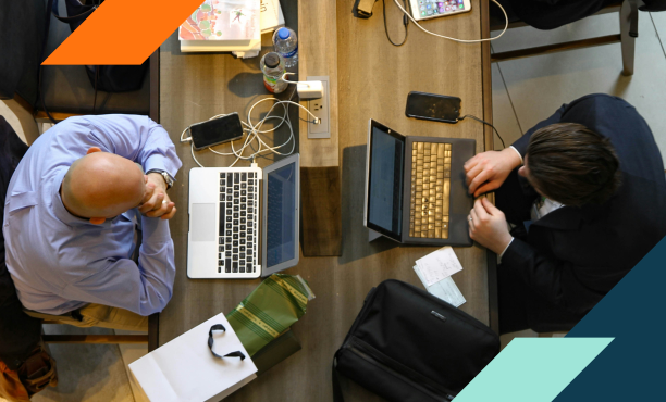 Image of two people using computers