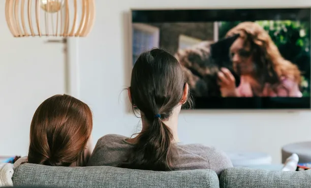2 people watching television