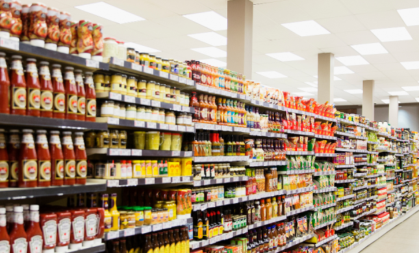 Rows of shelves of condiments in a supermarket 