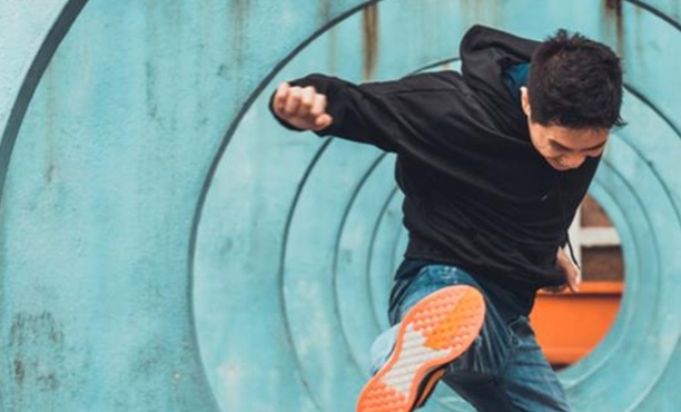 A young man kicks at the air