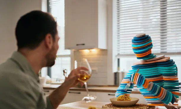 A Human and a Synthetic AI generated person sit down to a meal