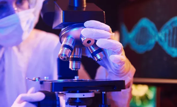 Image of a health professional operating a microscope
