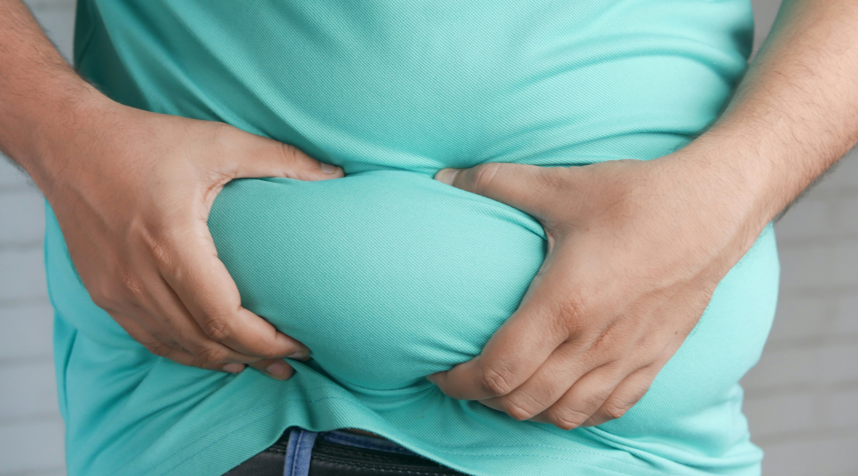 a man holding his bulging belly