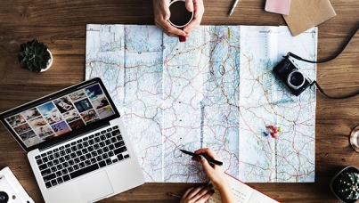Travel Planning with a map and laptop