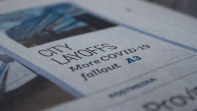 Image of newspaper which reads: CITY LAYOFFS More COVID-19 fallout