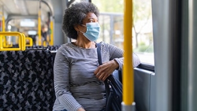 Older woman sitting on a bus, wearing face mask | Covid-19 crisis and unemployment | Ipsos
