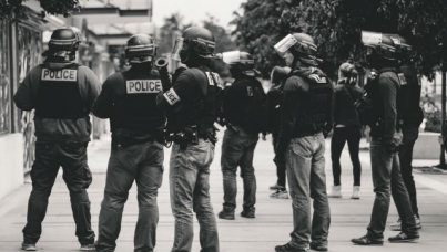 Greyscale image of armed police grouped together