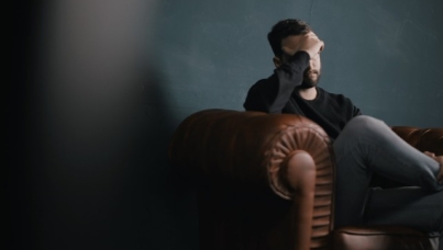 Worried man sitting on sofa