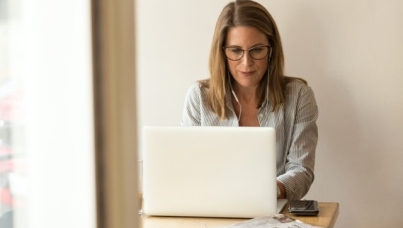 Woman working at computer at table