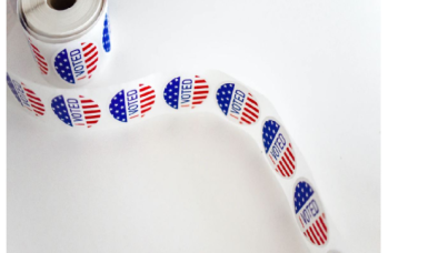 Image of roll of US "voted" stickers.