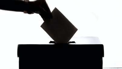 Person Putting Ballott into Box 