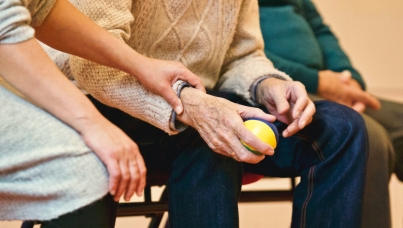 Care Worker Holding Hand of Elderly Person