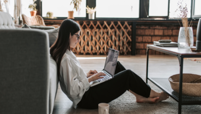 Person sitting on floor with laptop 