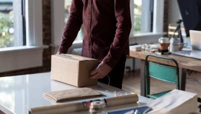 Person wrapping package for delivery