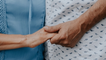 Elderly person holding hands