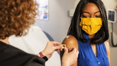 Person with mask getting injection