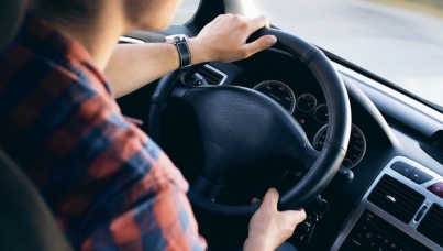 Person behind steering wheel