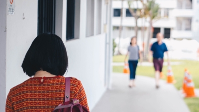 Asian Woman walking housing estate singapore