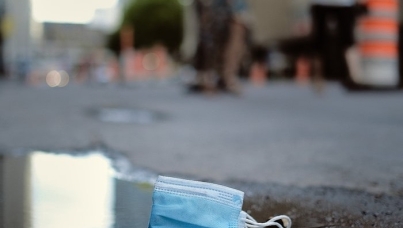 Discarded face mask in puddle