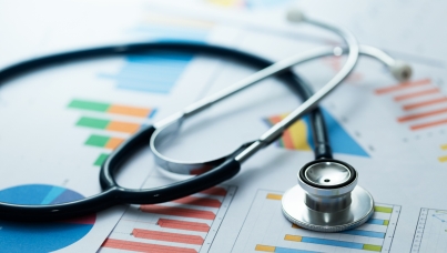 Stethoscope resting on bar charts
