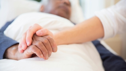 Patient and nurse holding hands