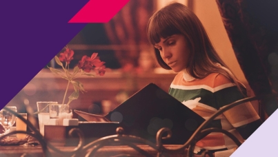 Picture of a woman looking at paper menu in a restaurant