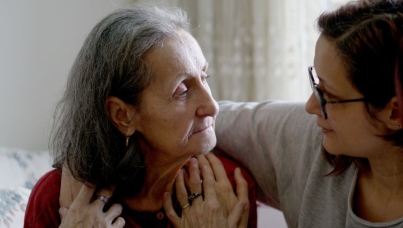 A young woman with her arm around the shoulders of an older woman