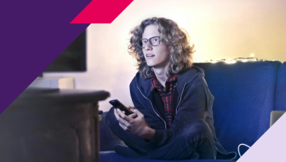 Image of a person watching TV while sitting on a couch