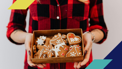 Person holding a box of holiday cookies as a gift