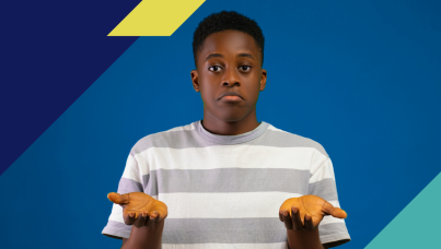 Photo of a boy holding his hands up ambivalently