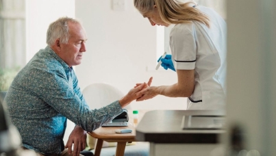 Patient and nurse conducting a diabetes test