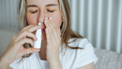 Woman with nasal spray