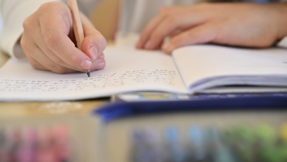Child writing in a notebook