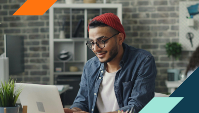 photo of man wearing a knit hat using a computer
