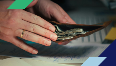 person putting money in wallet while doing paperwork
