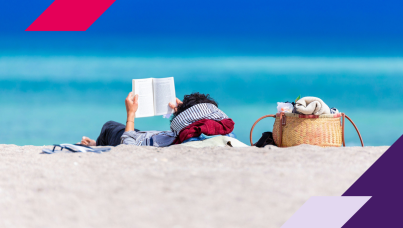 person sitting on beach reading a book