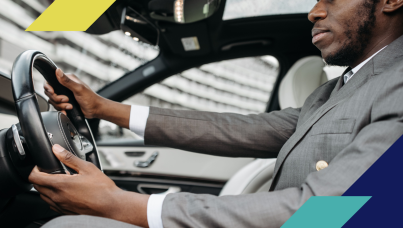 Image of a man driving a car wearing a suit