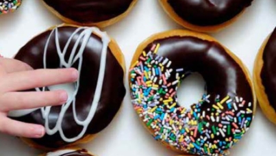 Hand reaching for a donut