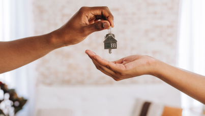 Real-estate-agent-giving-man-the-keys-to-his-new-home