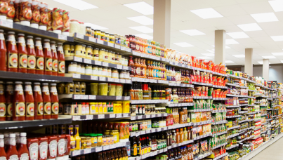 Rows of shelves of condiments in a supermarket 