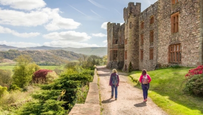 Castle wall with visitors and gardens
