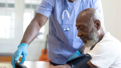Patient having blood pressure taken by doctor