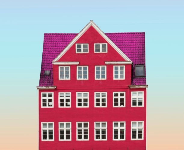 pink house front against a blue sky