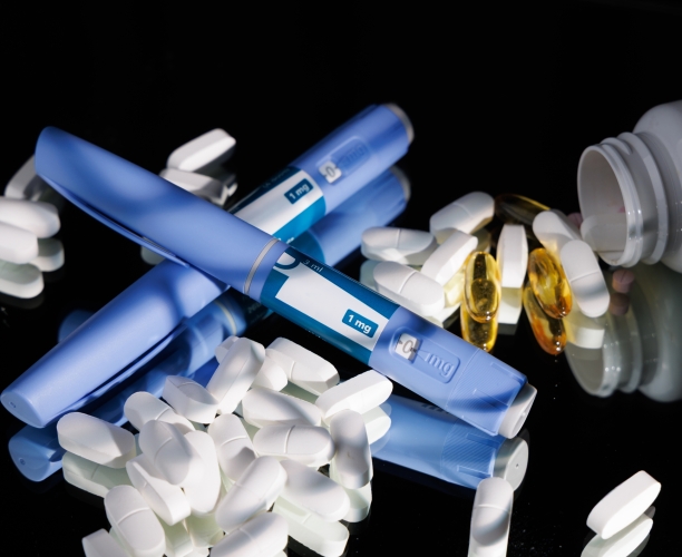 glp-1 medications on a black glass tabletop