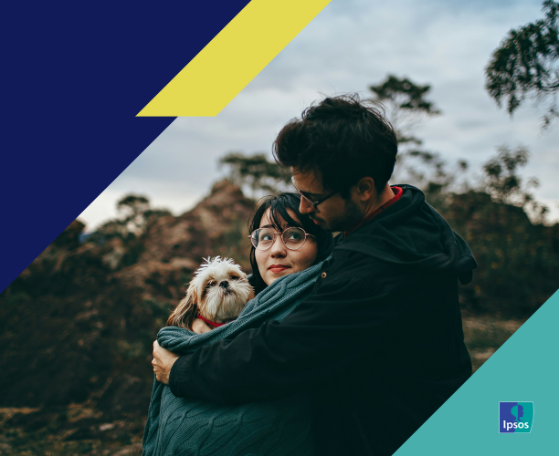 Couple hugging while holding a dog