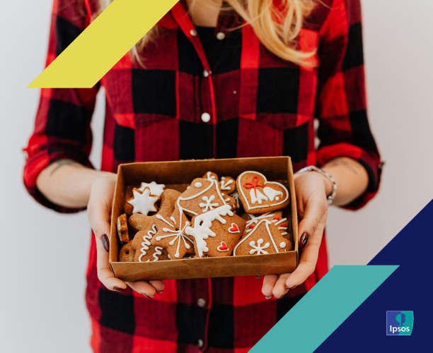 Person holding a box of holiday cookies as a gift