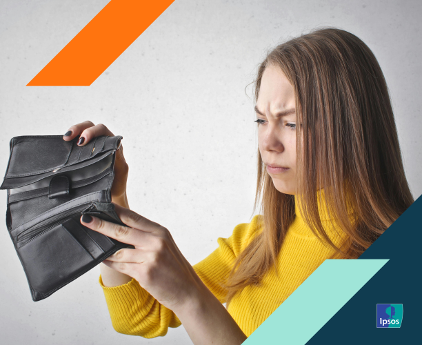 woman looking into empty wallet