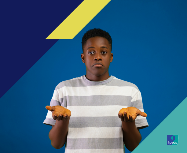 Photo of a boy holding his hands up ambivalently