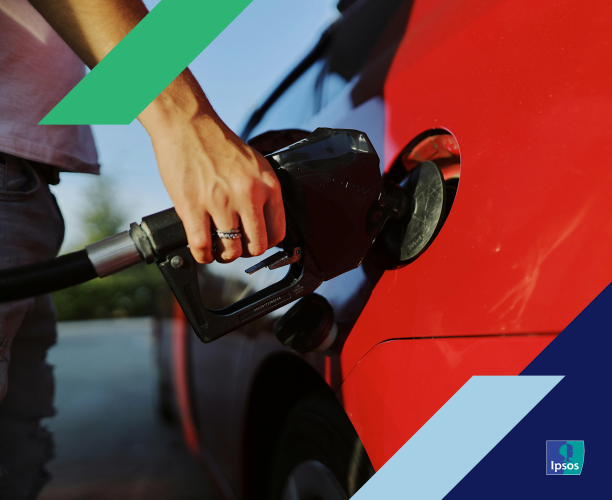 Photo of a person pumping gasoline