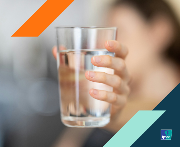 Photo of hand extending a glass of water